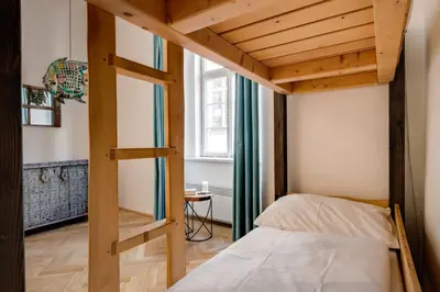a bedroom with a bunk bed and a ladder at Curiosity apartments in Prague