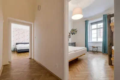 a room with a bedroom with a bed and a window at Curiosity apartments in Prague