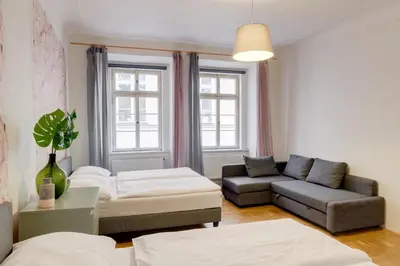 a living room with a couch and a table at Curiosity apartments in Prague