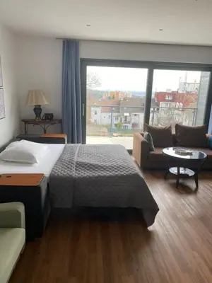 a bedroom with a bed and a couch and a window at Klapka 08 in Prague