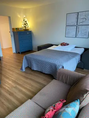 a bedroom with two beds and a couch and a dresser at Klapka 08 in Prague