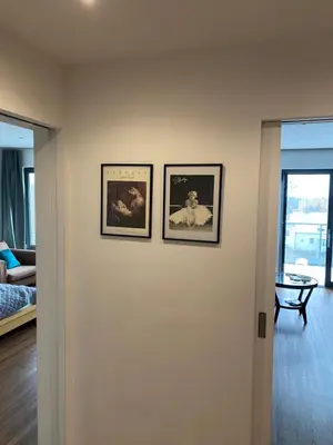 three framed pictures on a wall in a living room at Klapka 08 in Prague