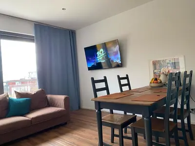 a living room with a dining room table and a couch at Klapka 08 in Prague