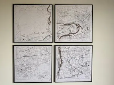 four framed drawings of maps on a wall at Klapka 08 in Prague