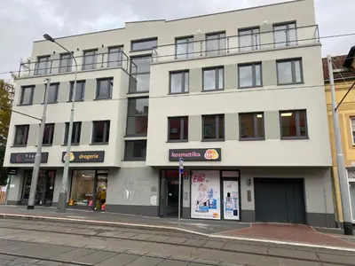 a white building on a city street with a street at Klapka 08 in Prague