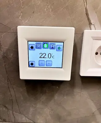 an electrical outlet with an ipod on a counter at Nekazanka studio apartment in Prague