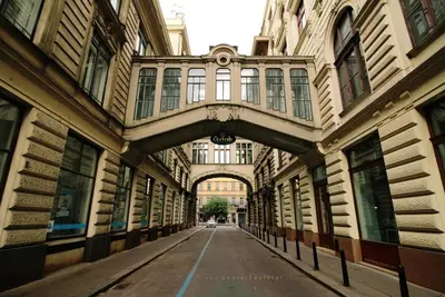 an empty street with an archway between two buildings at Nekazanka studio apartment in Prague