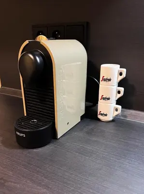 a toaster and a coffee mug next to a cup at Nekazanka studio apartment in Prague