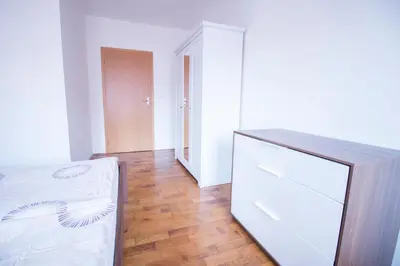 a room with a bed and a dresser and a hallway at Apartments Old Town Square 27 in Prague