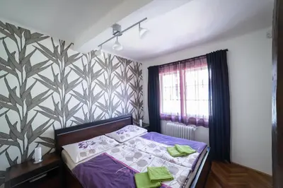 a bedroom with a bed and a wall at Apartments Old Town Square 27 in Prague