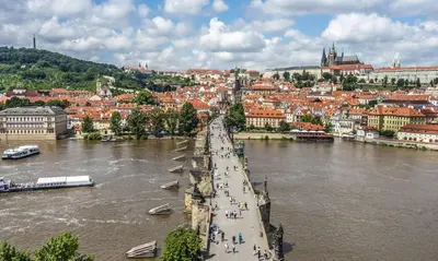 a hallway with white walls and a door with a picture at Spacious apartments near the river Prague in Prague