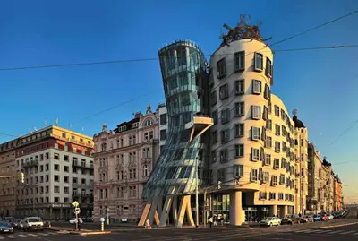 a building with a glass tower next to a street at Spacious apartments near the river Prague in Prague