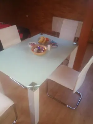 a white table and chairs with a plate of food on it at Villa Barrandovská in Prague