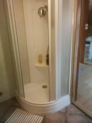 a shower with a glass door in a bathroom at Villa Barrandovská in Prague