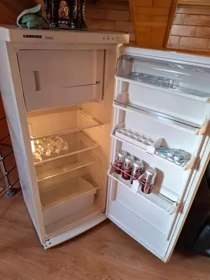 an open refrigerator with its door open and food inside at Villa Barrandovská in Prague