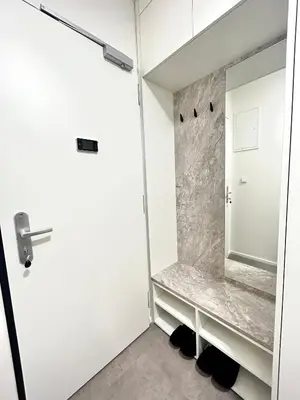 a bathroom with a white door and a mirror at Mozart Apartments Prague in Prague
