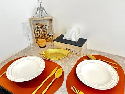 a table with plates and utensils on a table at Mozart Apartments Prague in Prague