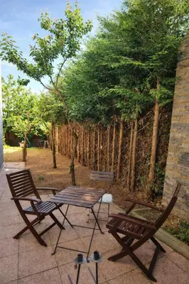 two chairs and a picnic table on a patio at Garden Suite - KindStay Suites Prague Airport in Kněžívka