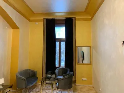 a living room with two chairs and a window at TDC33-boo in Prague
