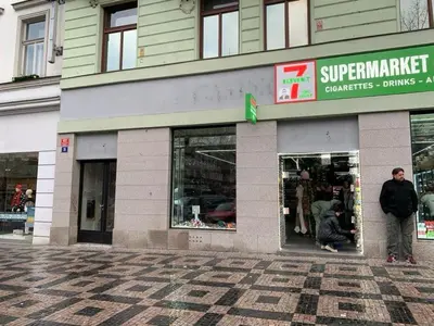a man standing in front of a store at TDC33-boo in Prague