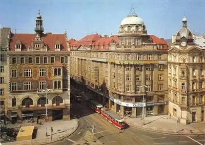 a city with buildings and a street with a bus at TDC33-boo in Prague