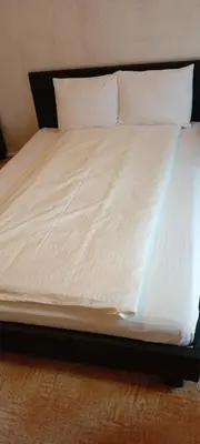 a bed with white sheets and pillows on it at TDC33-boo in Prague