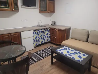 a kitchen with a couch and a table in a room at Studio Carolina in Mratín