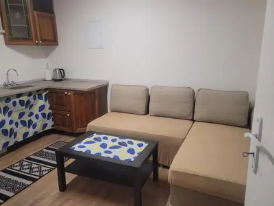 a living room with a couch and a table at Studio Carolina in Mratín