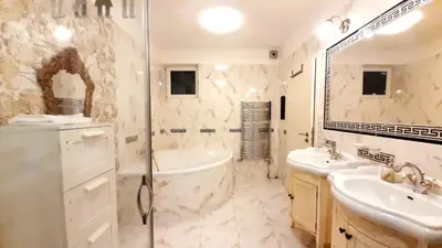 a bathroom with a tub and a sink and a shower at Spacious Suite - KindStay Suites Prague Airport in Kněžívka