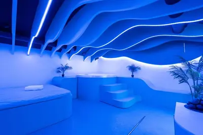 a room with blue lighting and a sink at SPA SPA Legerova in Prague