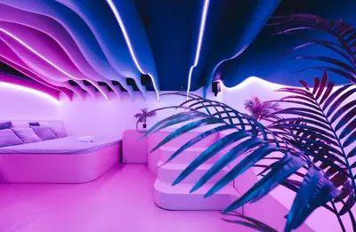 a living room with pink lighting and a couch at SPA SPA Legerova in Prague