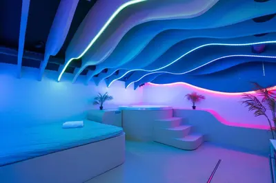 a room with a bed and a wave mural at SPA SPA Legerova in Prague