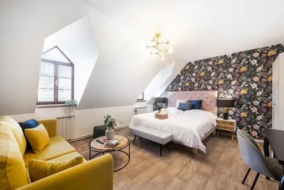 a bedroom with a bed and a couch at Penzion Dubina in Litoměřice