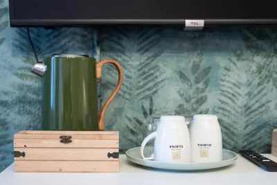 two coffee mugs and a wooden box on a table at Penzion Dubina in Litoměřice