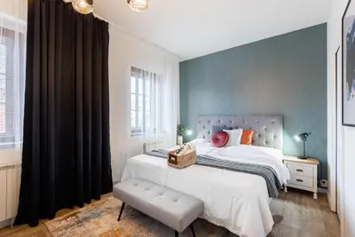 a bedroom with a large bed with a white bedspread at Penzion Dubina in Litoměřice