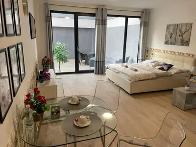 a living room with a bed and a glass table at O2 Arena - Alex Apartment Praha in Prague