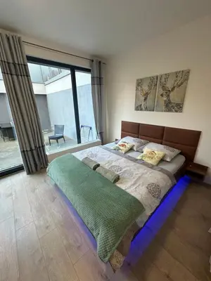 a bedroom with a large bed and a large window at O2 Arena - Alex Apartment Praha in Prague