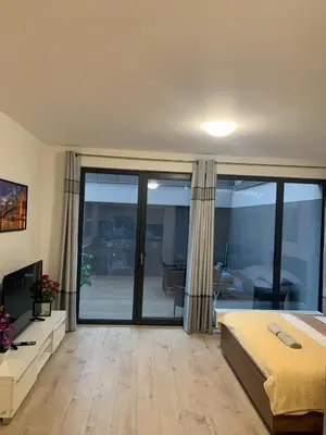 a bedroom with a bed and a sliding glass door at O2 Arena - Alex Apartment Praha in Prague