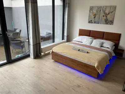 a bedroom with a bed and a large window at O2 Arena - Alex Apartment Praha in Prague