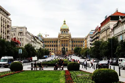 a large building with a clock tower in a city at TDC31, boo in Prague