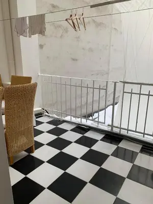 a bedroom with a crib and a checkered floor at TDC31, boo in Prague