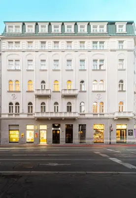 a large white building with many windows on a street at R16 Residences Prague in Prague
