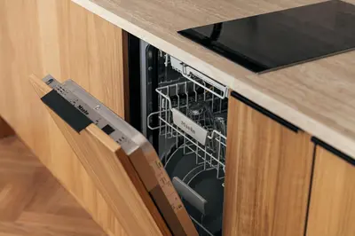 a dishwasher in a cabinet with its door open at R16 Residences Prague in Prague