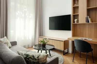 a living room with a couch and a tv at R16 Residences Prague in Prague