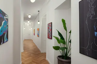 a hallway with white walls and a potted plant at R16 Residences Prague in Prague