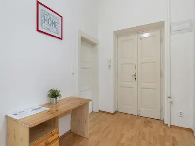 a room with a wooden desk and a door at Apartment Old Town home-1 by Interhome in Prague
