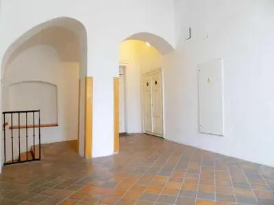 an empty room with white walls and a tile floor at Apartment Old Town home-1 by Interhome in Prague