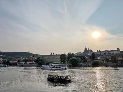 a boat on a river with a city in the background at Apartment Old Town home-1 by Interhome in Prague