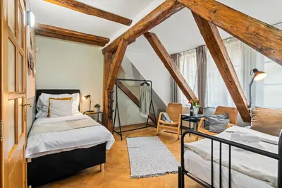 two beds in a room with wooden beams at Charles Bridge Historical APTs by Michal&Friends in Prague
