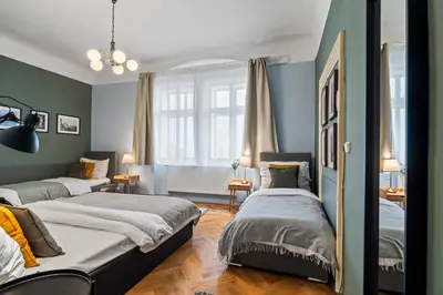 two beds in a room with blue walls at Charles Bridge Historical APTs by Michal&Friends in Prague